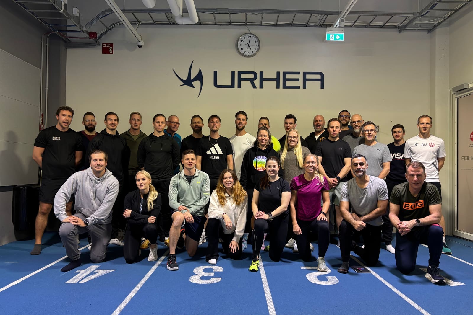 Participants of the Hamstring Workshop standing on the indoor track at Urhea, November 2025.